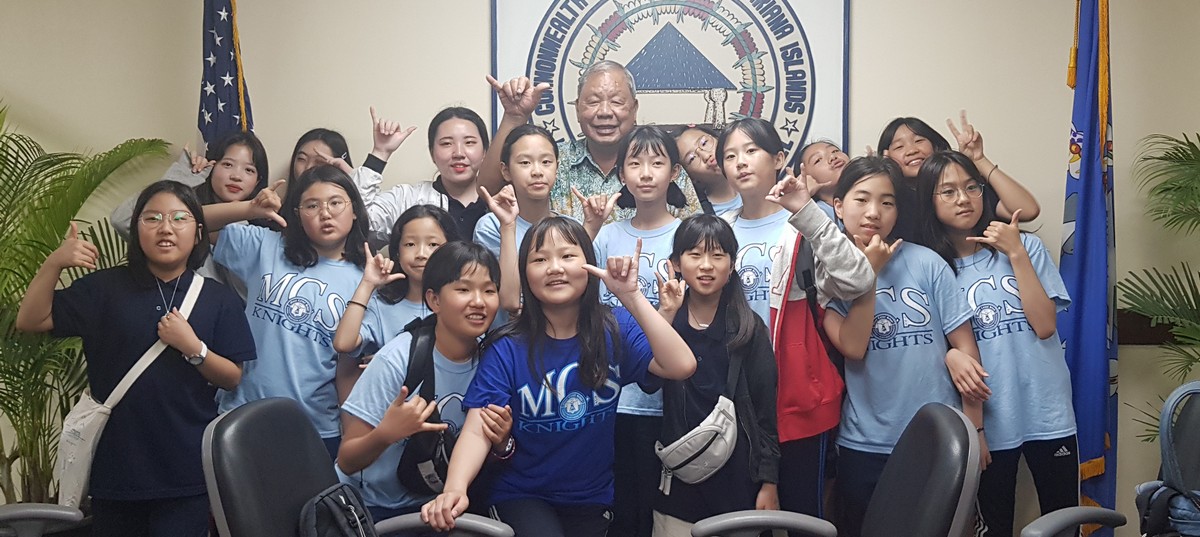 Saipan Mayor David M. Apatang poses with visiting Korean students at his office on Friday.