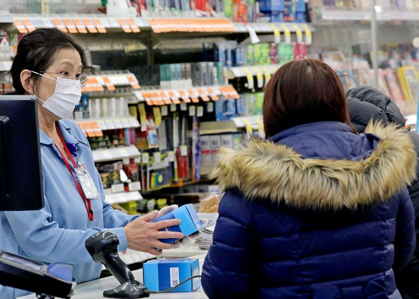 A sales clerk at a pharmacy rings up a purchase of face masks as fears of the coronavirus continues, Friday, in Chicago. A Chicago woman was diagnosed with the dangerous new virus from China, health officials announced Friday. AP