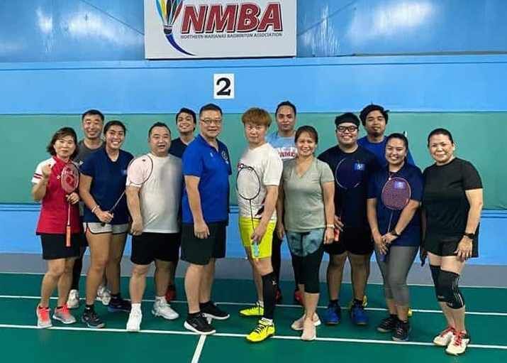 Northern Marianas Badminton Association members and officials join South Korean Ji Woong Jung, center, for a photo after the clinic, Sunday, at the TSL Sports Complex. Contributed photo