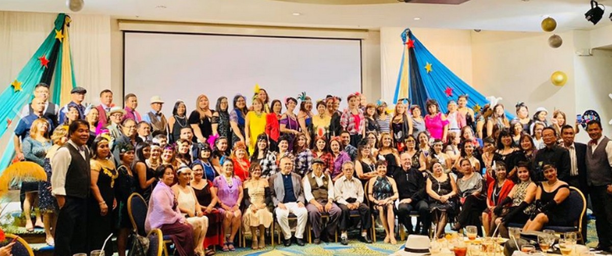 Members of the Saipan Unity Lions Club led by their president Elizabeth Escober-Mendiola distribute school supplies to children. Contributed photo