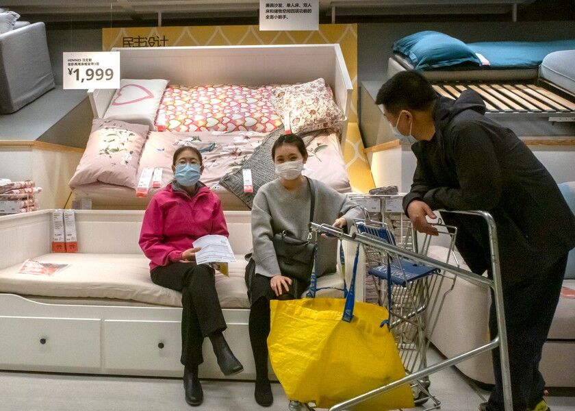 People wear face masks to protect against coronavirus infection as they shop at an IKEA store in Beijing, Saturday. AP