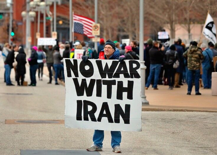Air Force veteran Mike Fitzgerald, center, from Kirkwood, Mo., stands near a protest outside the Federal Courthouse in St. Louis on Saturday, Jan. 4, 2020. AP
