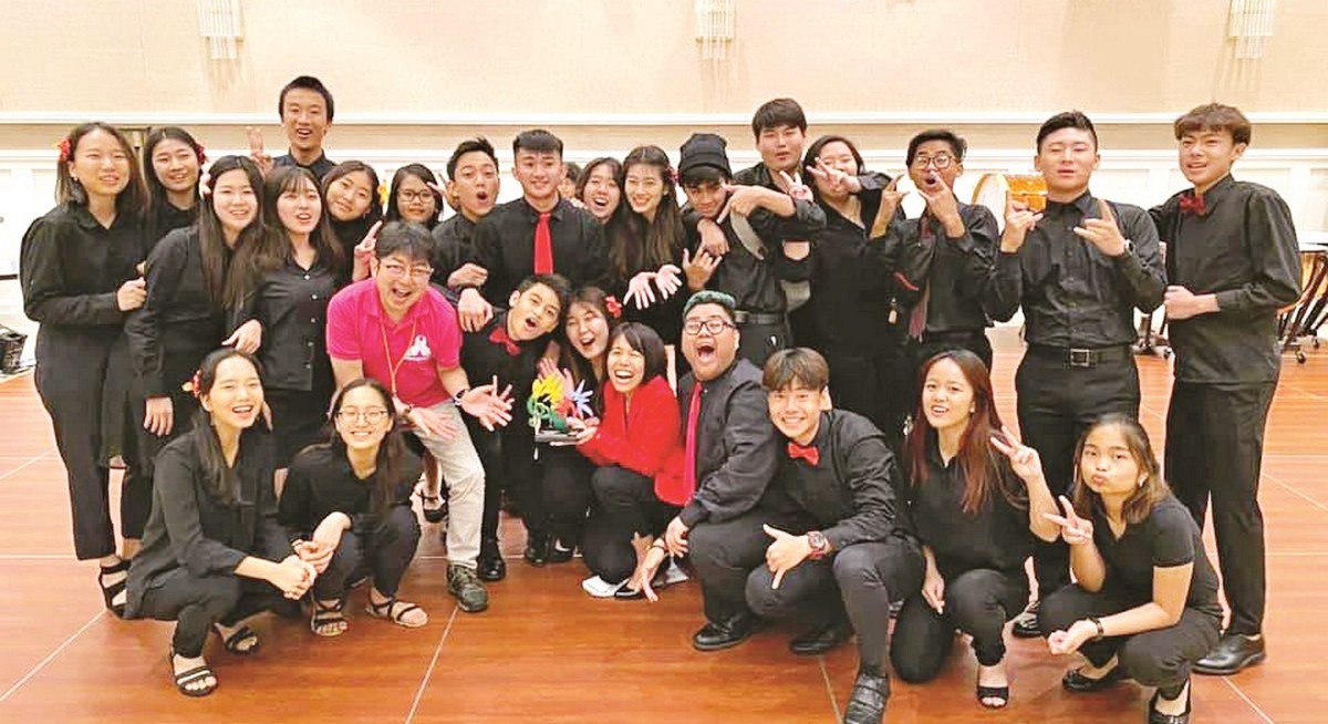 The Marianas High School Concert Band won gold and was named one of the command performance groups — one of the highest honors at the Tumon Bay Music Festival. In photo are band director Atsuko Eck, center, foreground, and adjudicator Atsushi Yamashita, third left, with the band members. Contributed photo