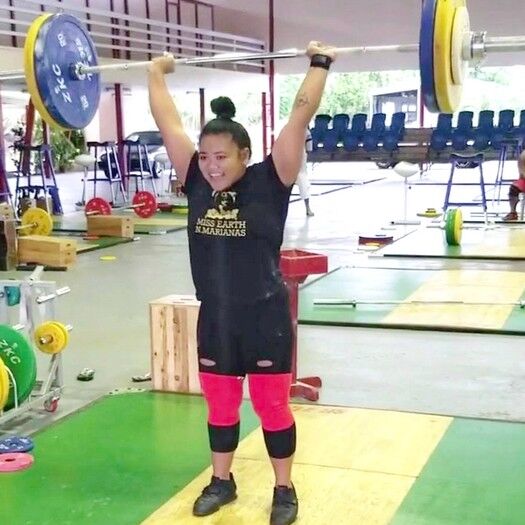 Antonette Labausa smiles as she completes the clean & jerk at a training camp in Samoa. Contributed photo