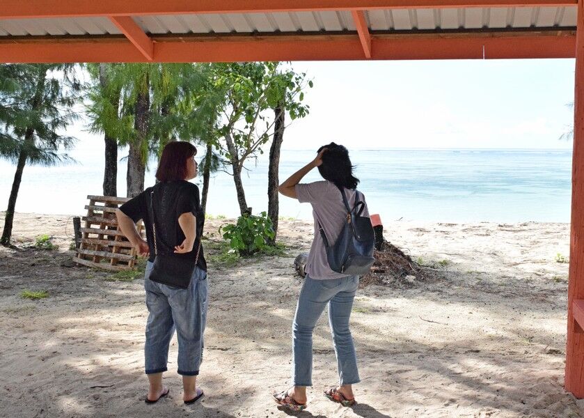 CAPTITwo tourists take shelter at a pavilion at San Antonio beach last week. Photo by Emmanuel T. EredianoON