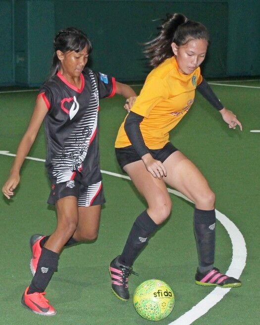 Kanoa Football Club’s Khristelle Itaas protects the ball as Southern United’s Kaithlyn Chavez closes in  during Sunday’s championship game of the 2019-2020 Holiday Futsal Jam U16 Girls Division at the TSL Sports Complex. Photo by James F. Sablan Jr. 