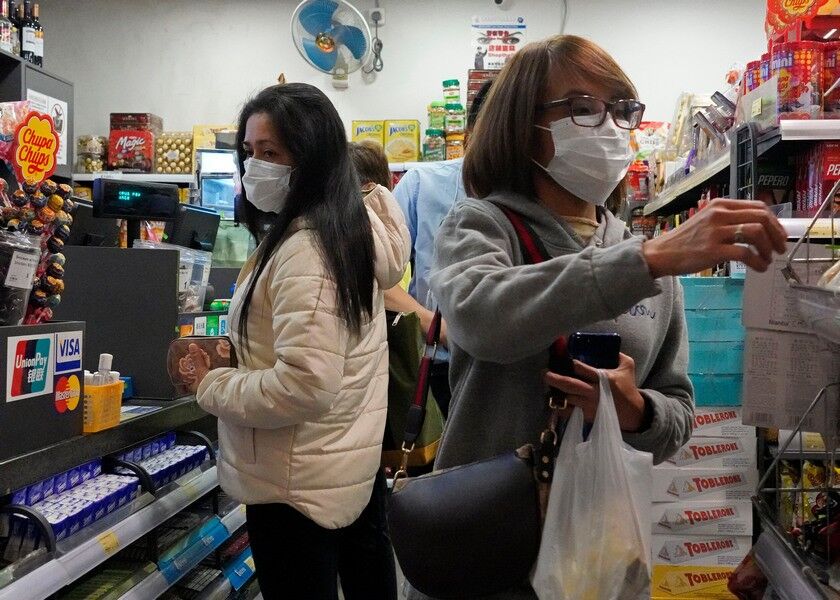 People wear protective face masks as they make purchases from a convenience store in Hong Kong, Monday. AP