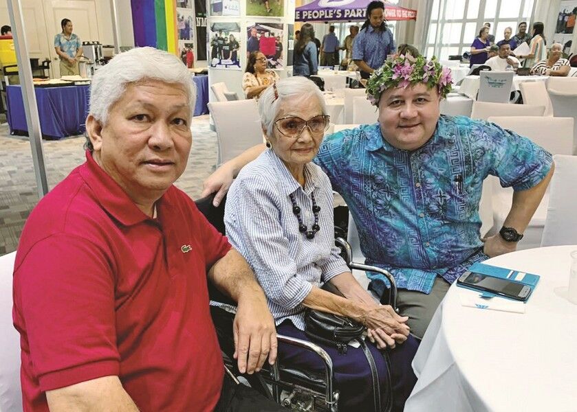 Retired Lt. Col. Lawrence F. Camacho, right, poses with former Rep. Donald Barcinas, and Maria Castro during the NMI Democratic Party general membership meeting at Grandvrio Resort Saipan on Saturday.