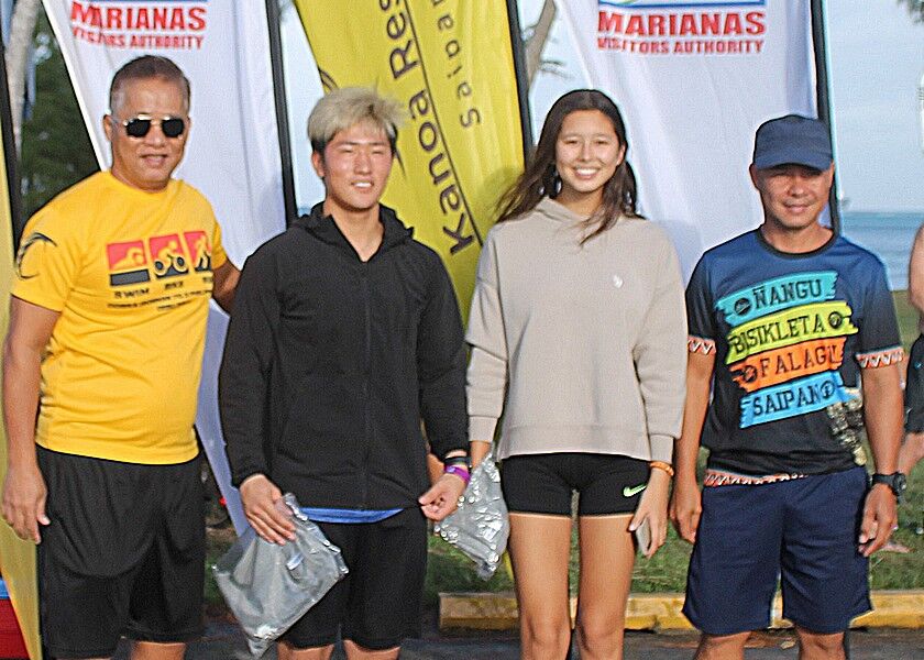 SIS Geckos Tiana Cabrera and Kuu Nishimura pose for a photo  during the award ceremony of the 5th Aquathon & 10km Run at the Kilili Pavilion. Photos by James F. Sablan Jr. 