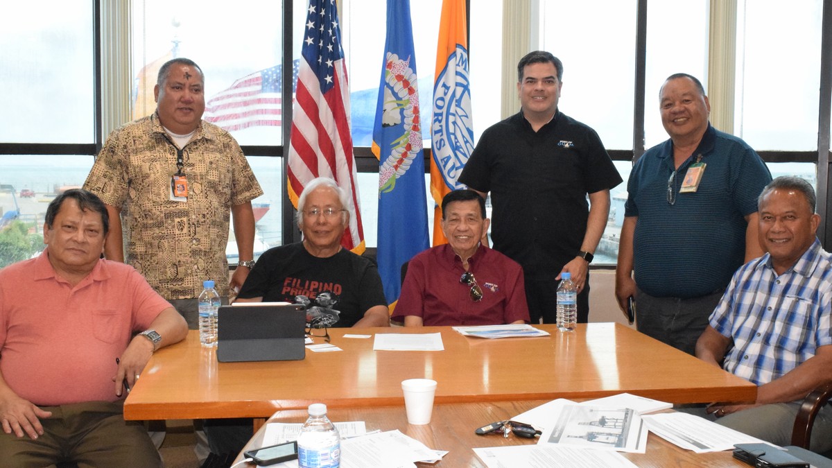 Commonwealth Ports Authority board members Pete P. Reyes, third left, Ramon A. Tebuteb, right, and Joseph Diaz, left, with CPA Executive Director, Chris Tenorio, second left, and Port of Saipan manager Rodney Taisacan, second right, pose for a photo with Port Authority of Guam Chairman Francisco Santos and general manager Rory J. Respicio during a break in a meeting in the Port of Saipan conference room on Wednesday. Photo by Emmanuel T. Erediano