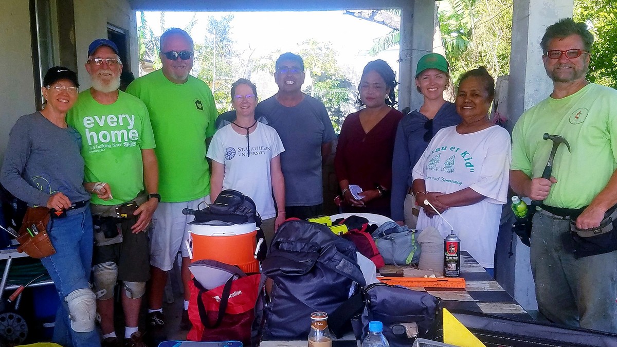 Mengrang Haruo, second right, and the writer, fourth right, pose for a photo with FEMA volunteers. Contributed photo