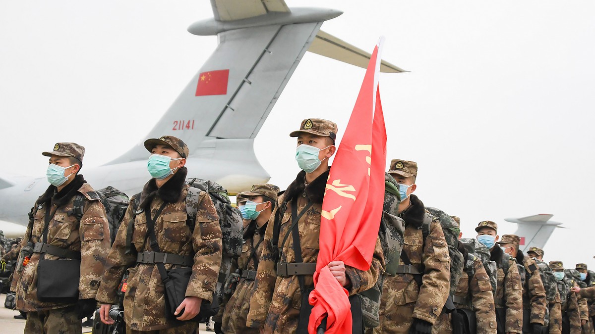 Chinese military medical staff members stand in formation after arriving at Wuhan Tianhe International Airport in Wuhan in central China’s Hubei Province, Sunday. AP