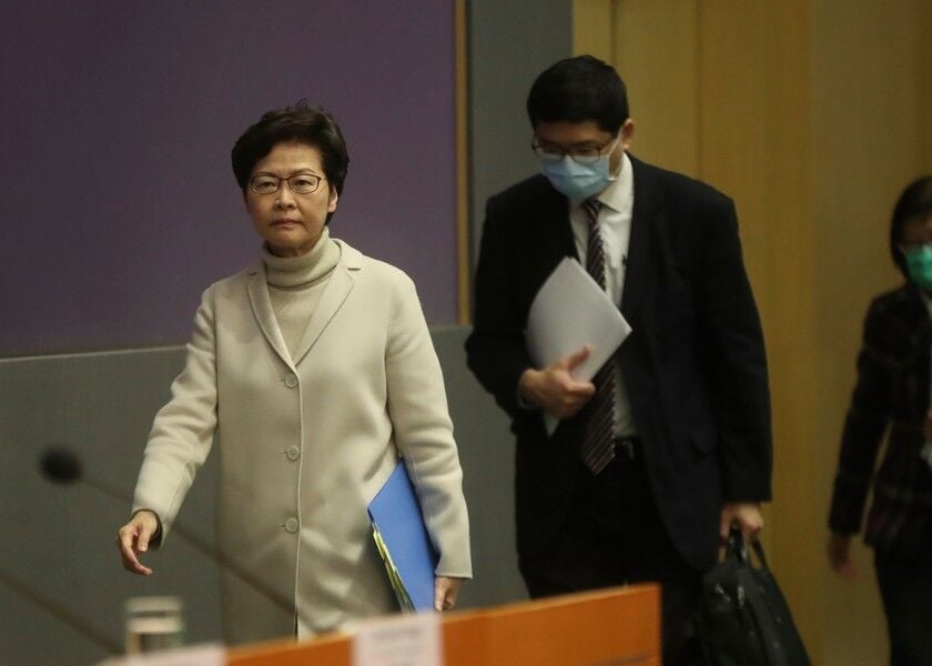 Hong Kong Chief Executive Carrie Lam arrives at her press conference without a protective face mask in Hong Kong, Monday. Lam says the city will shut almost all land and sea border control points to the mainland from midnight to stem the spread of the novel coronavirus from China. AP
