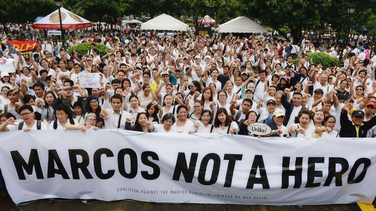 Protesters display a banner with an anti-Marcos slogan during a demonstration at a park in Manila on August 14, 2016, against plans to honour the late dictator Ferdinand Marcos with a state burial. About 2,000 people gathered in heavy rain to denounce Philippine President Rodrigo Duterte's plans to move late dictator Ferdinand Marcos' remains from his northern hometown to the National Heroes' Cemetery in the capital, Manila, next month. AFP photo