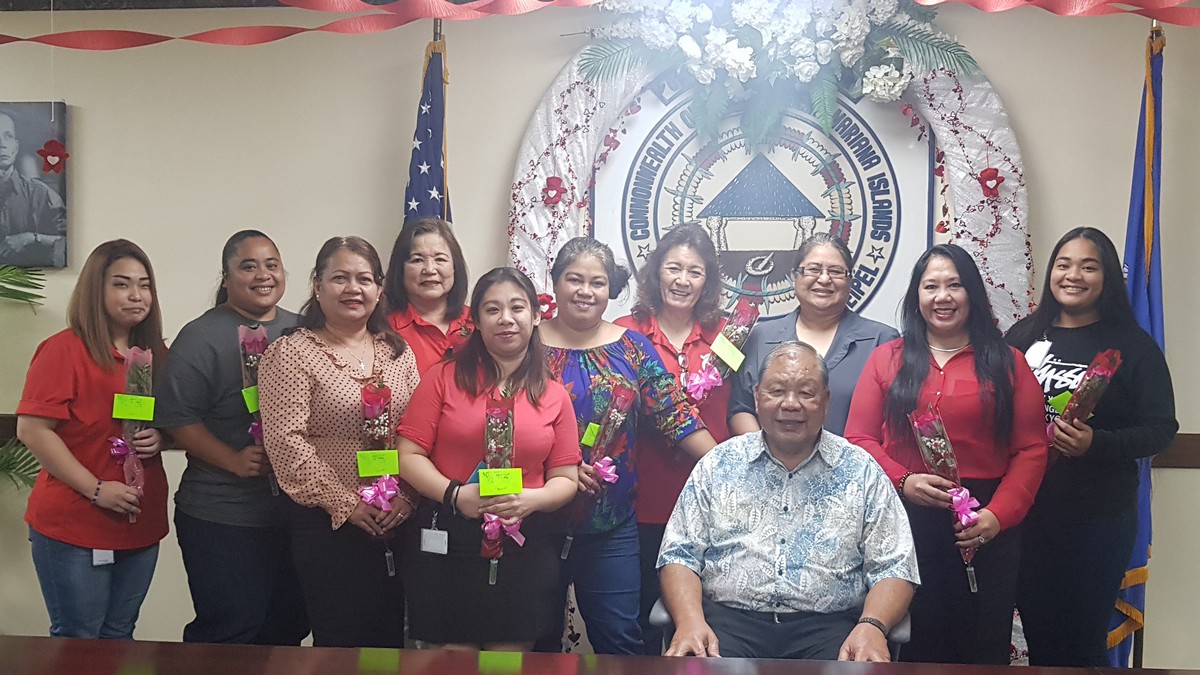 Saipan Mayor David M. Apatang poses with his female staff members after he gave each of them flowers on Valentine’s Day. Photo by Junhan B. Todiño