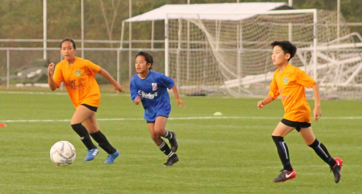 Shirley’s Haro and two Kanoa defenders chase after the loose ball during Saturday’s opening game of the Youth League Spring 2020 U13 coed division at the NMI Soccer Training Center in Koblerville. Photo by James F. Sablan Jr.