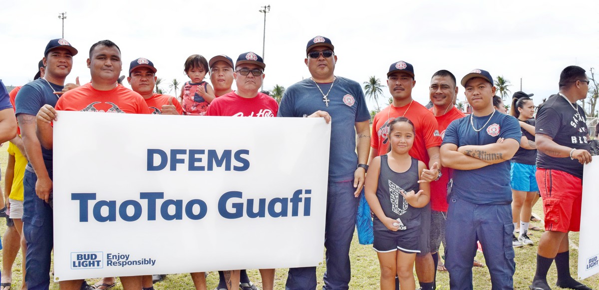 Taotao Gaufi members pose with their banner during the opening of the 2020 Islandwide Co-ed Bud Light Softball League. Contributed photo