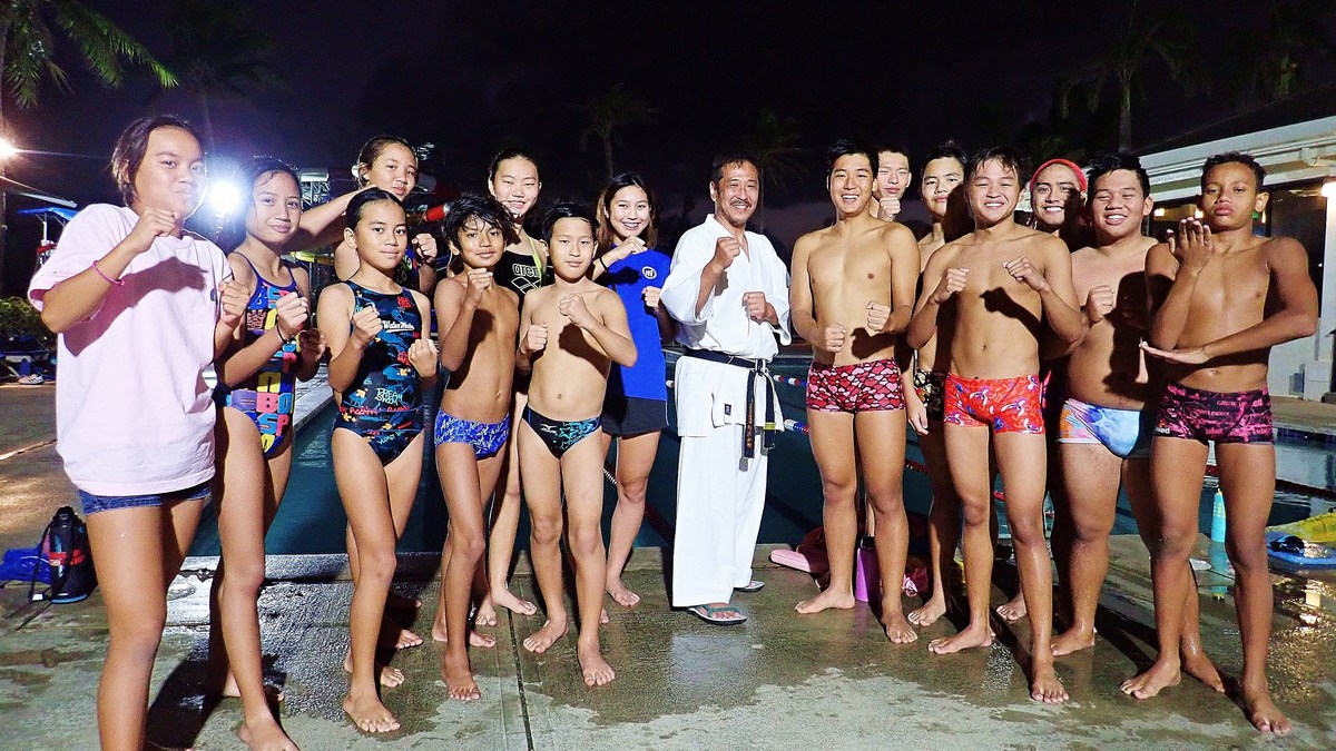 A group picture with Master Kato. The swimmers swam to cool down after their karate training. Photos by James Sablan Jr.