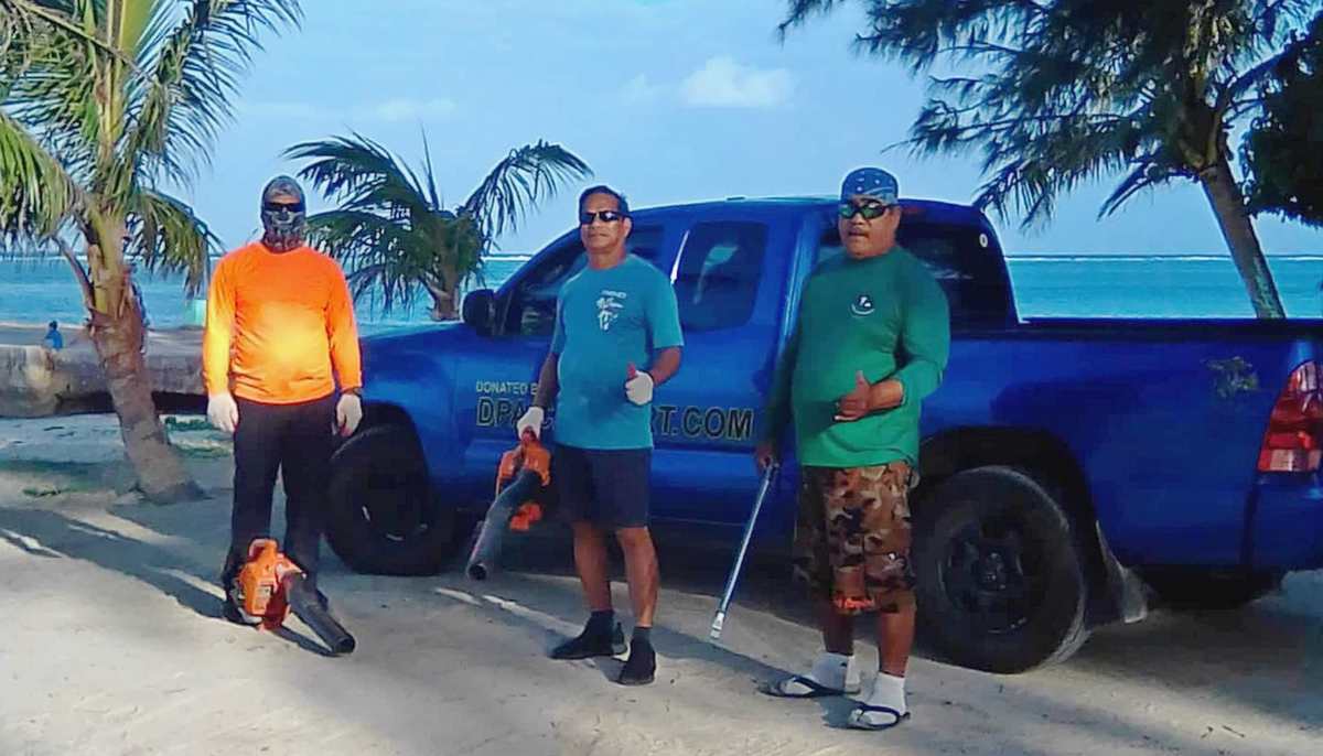 Community volunteers Max Aguon, Akakiy Alexander, and Joe Cabrera pose after a cleanup operation. Contributed photo