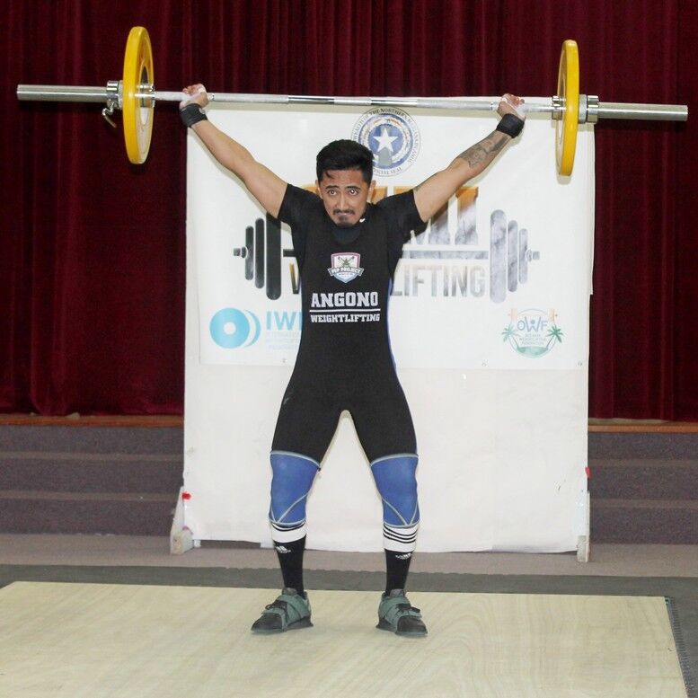 Brandon Regis completes the snatch during Saturday’s Northern Marianas Cup Weightlifting Tournament at the multi-purpose center in Susupe. Regis placed first in the 67kg division. Photos by James F. Sablan Jr. 