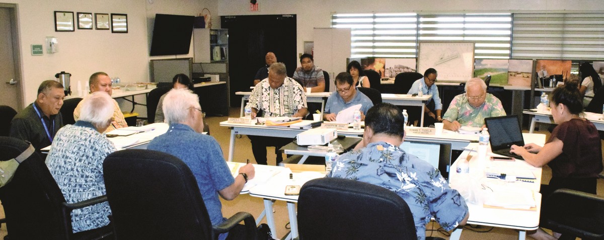 The board members of the Commonwealth Ports Authority review their notes during a break from a meeting on Thursday. Photo by Emmanuel T. Erediano