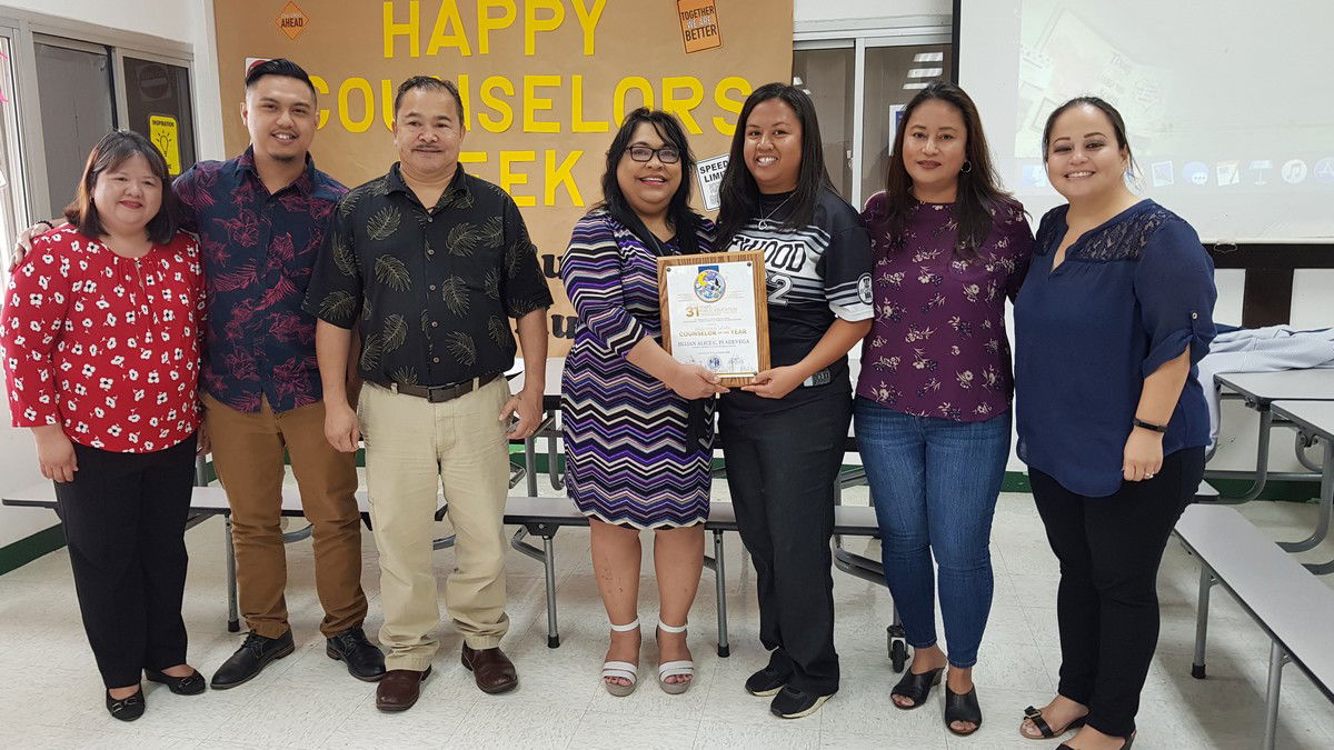 Hopwood Middle School’s Jillian Pladevega, third right, is the 2020 Counselor of the Year. Also in photo: Hopwood Middle School principal Rizalina Liwag, Public School System human resources personnel specialist Roman Tudela, Education Commissioner Dr. Alfred Ada, Board of Education Chairwoman Janice Tenorio, Associate Commissioner for Student and Support Services Dr. Yvonne Pangelinan, and PSS human resources director Lucretia Borja. Photo by Lori Lyn C. Lirio