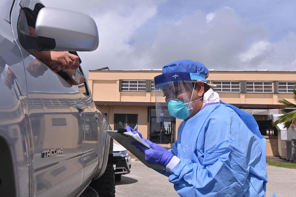 Several buses enter the Pacific Star Resort & Spa on Monday. Similar buses were seen unloading quarantined travelers from Hotel Santa Fe Guam on the same day. Photo by John O’Connor/The Guam Daily Post