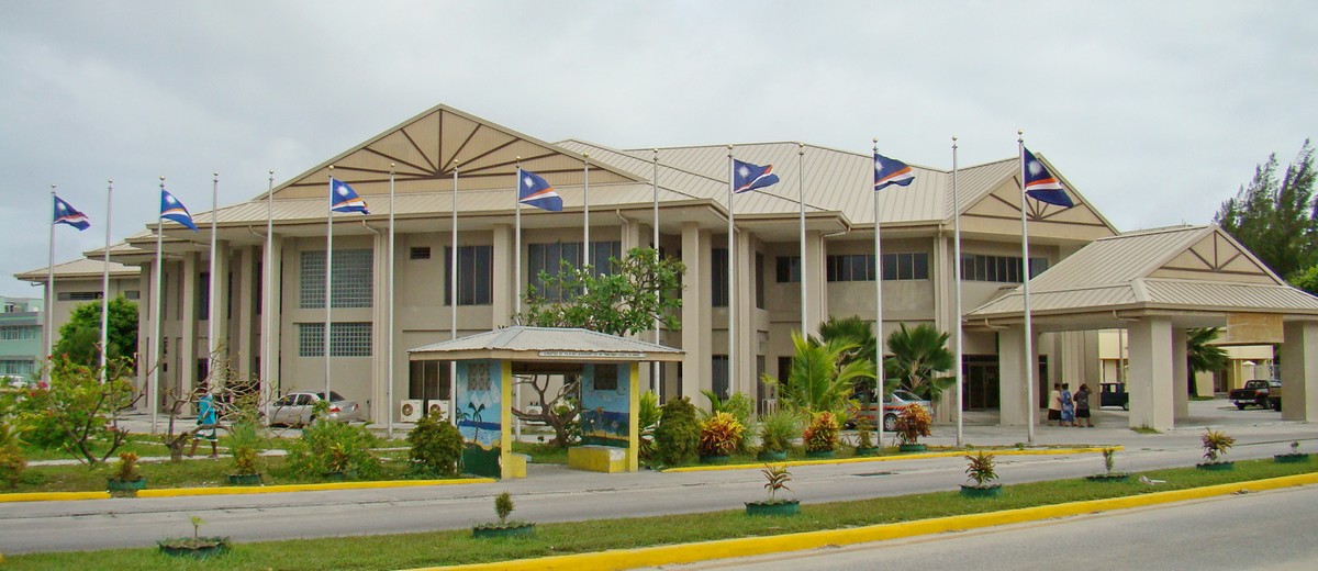 Marshall Islands flags fly in front of the capital building in Majuro. An audit of the government’s passport office has found numerous problems and “ineffective” management. Photo by Giff Johnson
