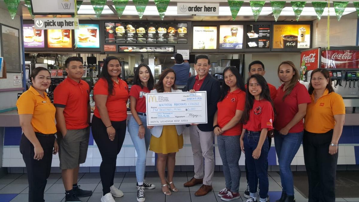 McDonald’s executive assistant to the president, Mable Ayuyu-Glenn, center, presents a check for $5,000 to Northern Marianas College Interim President Frankie Eliptico on Friday at McDonald’s Middle Road. Also in photo: Rutzel Perez, acting general manager of McDonald’s Garapan, Jocelyn Asistores, general manager of McDonald’s Middle Road, and NMC students. Contributed photo