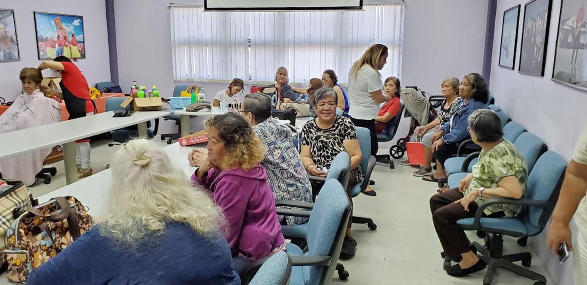 Senior citizens wait for their turn during IT&E’s makeover program at the Aging Center. Contributed photo