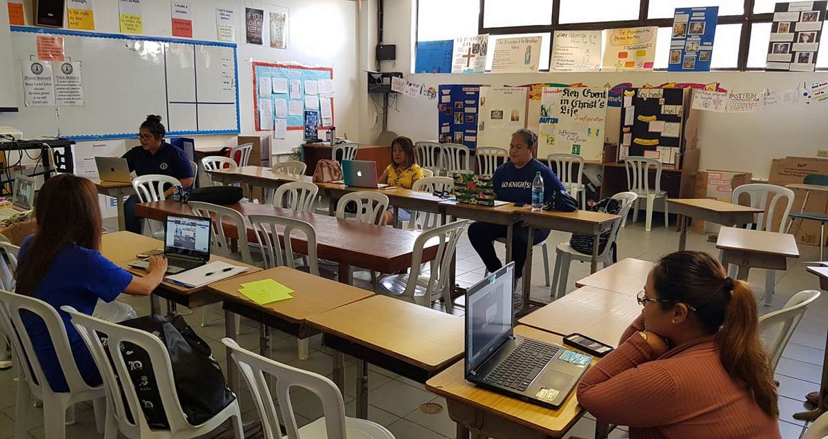 Victoria Deleon Guerrero, 2nd left background, Mount Carmel School director of Institutional Development, explains the four platforms that MCS teachers will use for online classes. Photo by Lori Lyn C. Lirio