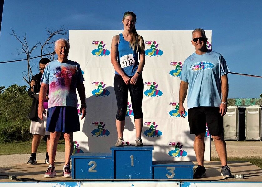 The top participant in the women’s division, Annika Snyder, center, poses with Triple J Chairman and CEO Robert Jones, left, and Triple J senior vice president Jay Jones, right, on Saturday during the conclusion of the Triple J 5k Bubble Color Run/Walk at Garapan Fishing Base. Photos by Prince Factor