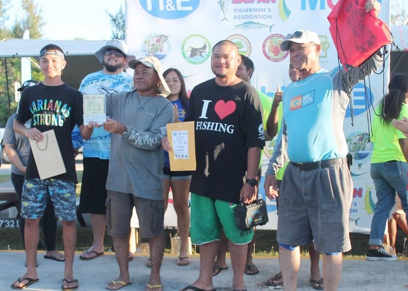 Members of team MARIANAS celebrate after topping the inaugural Wahoo in the Marianas Fishing Tournament on Saturday at the Smiling Cove Marina. Photos by James F. Sablan Jr.
