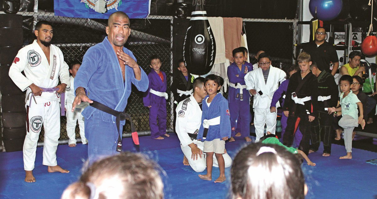 Cuki Alvarez explains an exercise drill to his young students during a Kids BJJ Class at the Trench Tech Gym. Photo by James F. Sablan Jr.