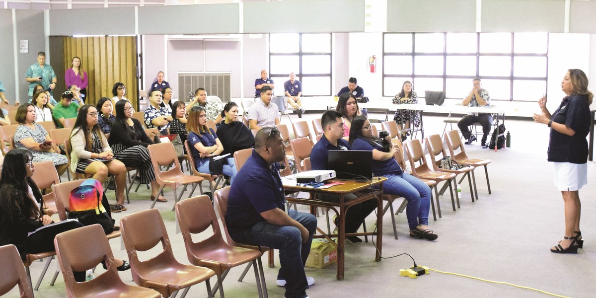Marianas Visitors Authority vice chairwoman Gloria Cavanagh, right standing, speaks before representatives of hotels and other local businesses at the multi-purpose center on Wednesday. Photo by Emmanuel T. Erediano