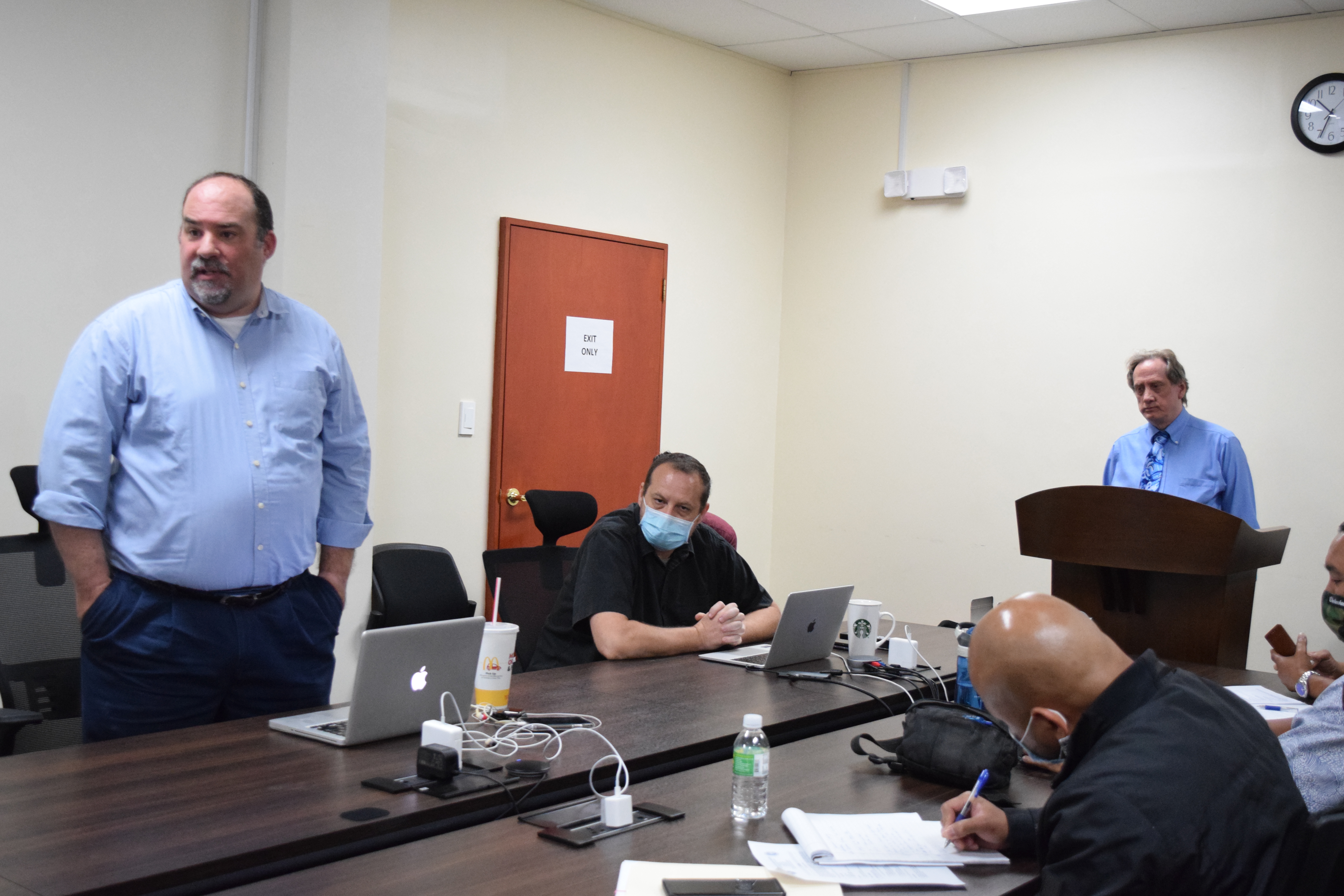 Commonwealth Casino Commission legal counsel Mike Ernest, left, talks to casino commissioners as attorney Michael Dotts, right standing, listens during last week’s meeting in the commission’s conference room. Photo by Emmanuel T. Erediano