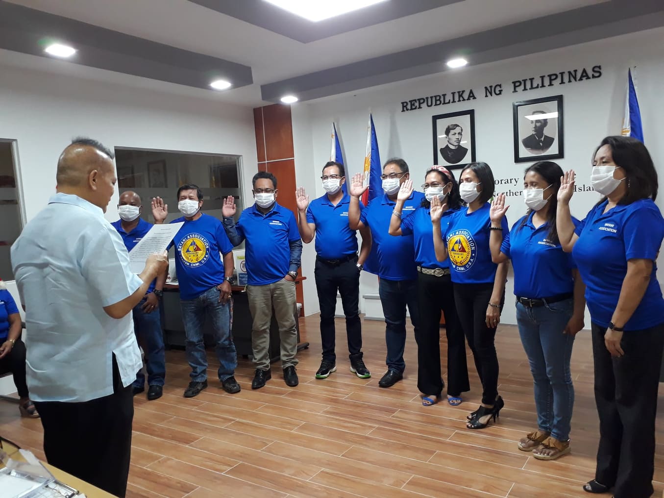 Philippine Honorary Consul Glicerio DM Arago, left,  back to the camera, swears in the new officers of the Bayani or Heroes Association in the CNMI. From right, Annamae Adaza, president; Yolanda de Ramos, vice president; Marie Paz Meister, secretary; Ladyvir Canape, treasurer; Mario Mayuga, auditor; Teogenes Mendoza, Rogelmar Dagahoya, Jaime Del Perlata and Ronald De Ramos, safety officers.  Bayani Association photo