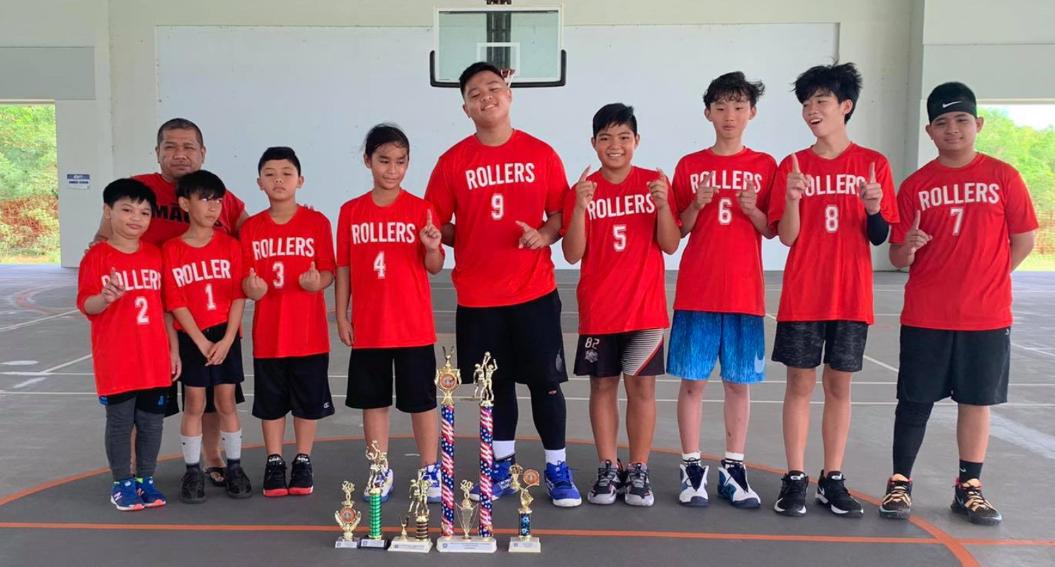 The Rollers Red pose with the championship and other trophies following Sunday's awards ceremony of the U13 RBA Holiday Tournament at the Koblerville gym.Contributed photo