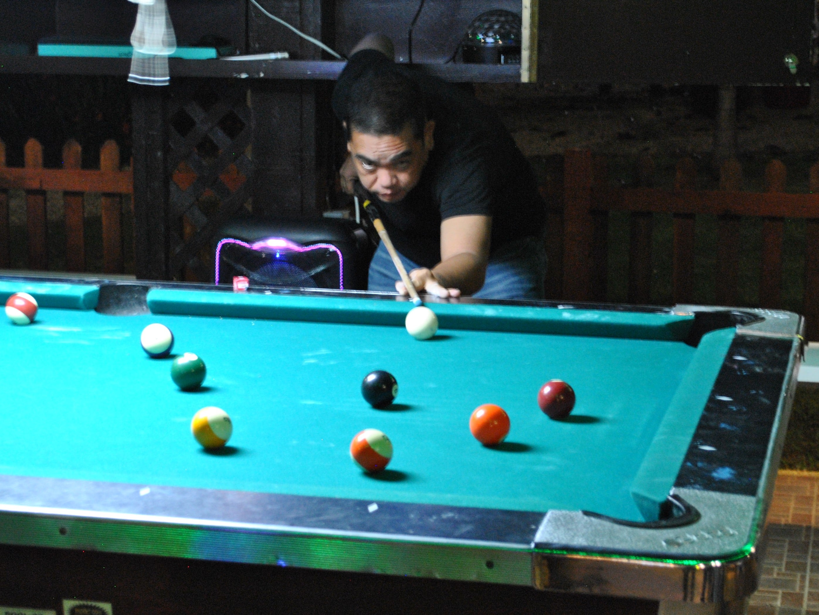 Nolan Cultura lines up for the shot during Sunday's Saipan Vegas Christmas Pool Tournament at the Saipan Vegas New Bamboo Bar.Photo by James F. Sablan Jr.