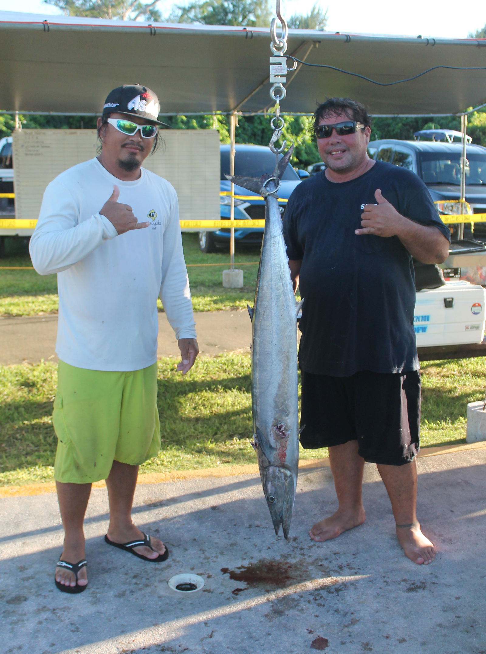 Chris Pangelinan, right, and crewmate of Borrow Fan pose with the 26.7lbs Wahoo during last Saturday's 16th Annaul Mahi-Mahi Derby held at the Smiling Cove Marina.