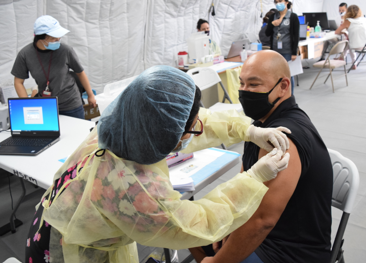 Commonwealth Healthcare Corp. medical director Dr. John M. Tudela receives the Covid-19 vaccine at the CHCC Medical Care and Treatment Site on Saturday.Photo by Emmanuel T. Erediano