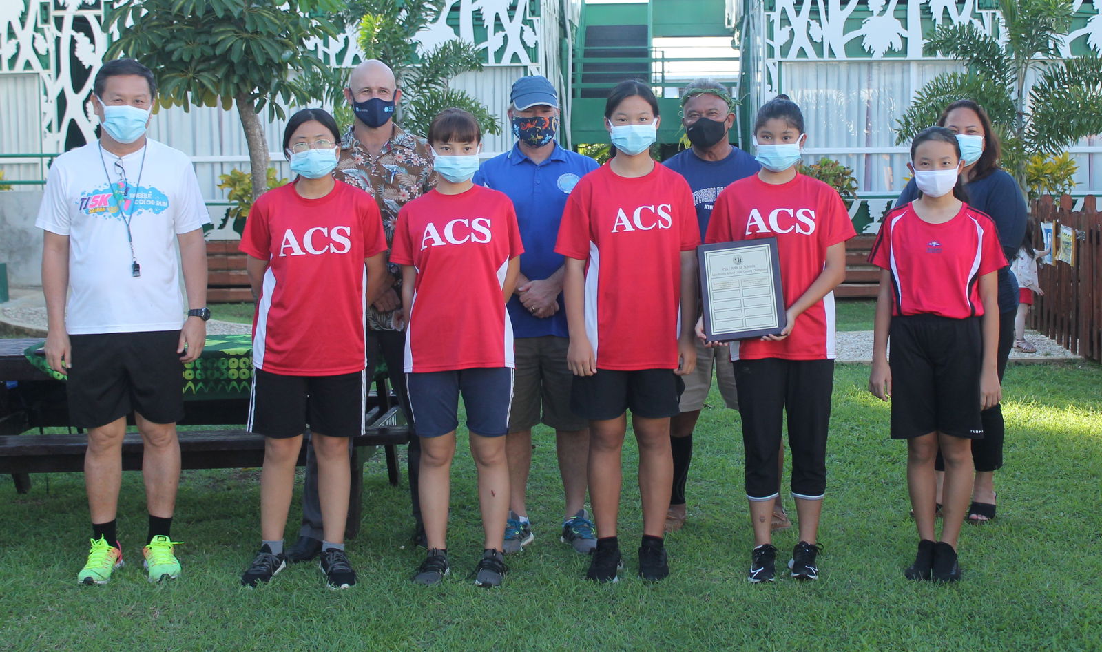 The girls of ACS pose with the perpetual trophy of the Middle School division during last Friday's award ceremony of the 2020-2021 PSS/NMA All School Cross Country held at the Saipan Vegas.