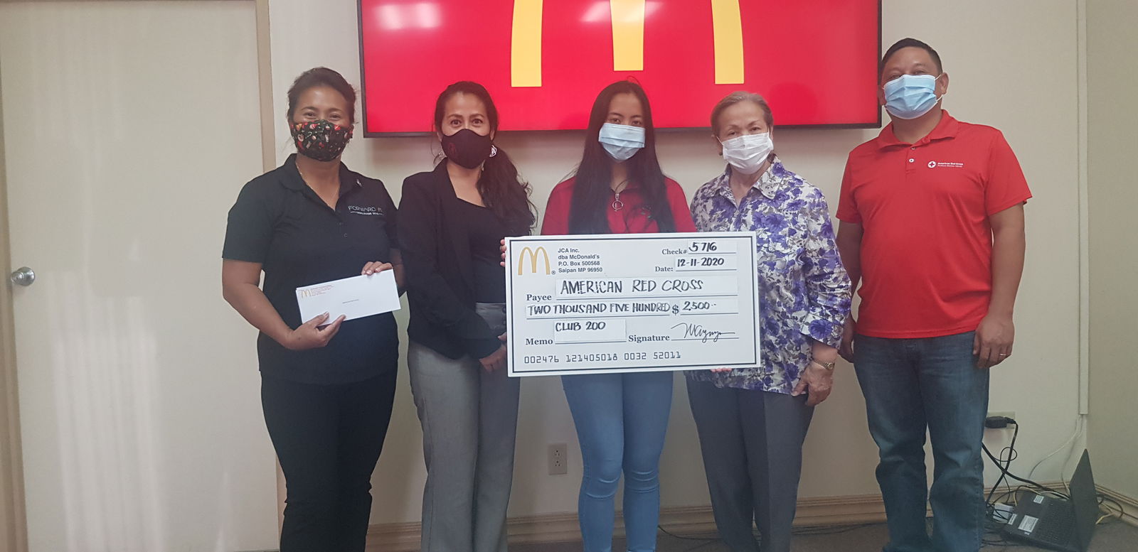 McDonald’s owner/operator Marcia Ayuyu, left, holds a check for the American Red Cross Club 200 as her daughter Maria Pilar, center, holds a ceremonial check. Also in photo are American Red Cross-NMI chapter chairwoman Tayna Belyeu-Camacho, second left, board member Jean Sablan, second right, and disaster program manager JD Tenorio.Photo by Emmanuel T. Erediano