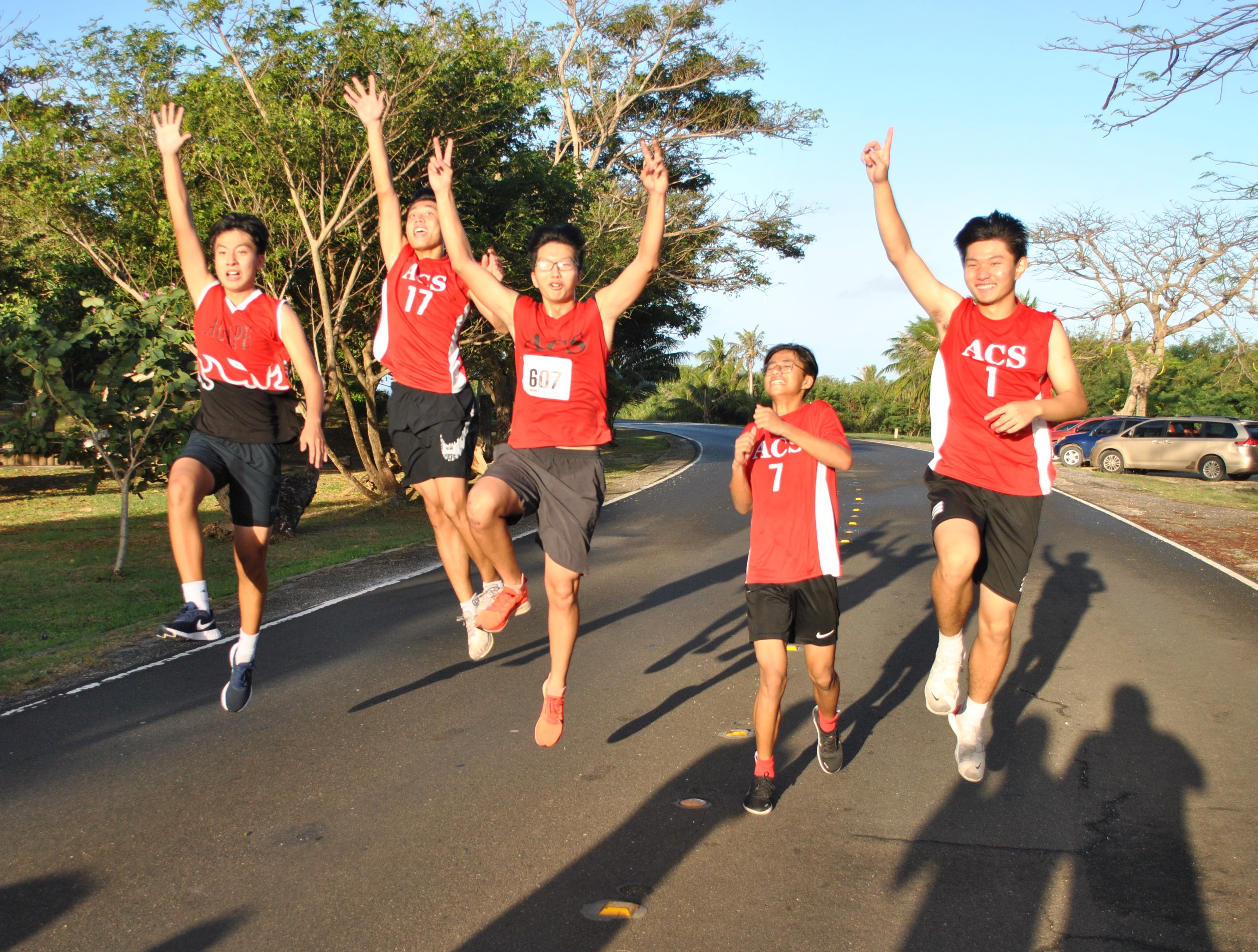 Members of Team Agape A jump in celebration of taking first place in the open mixed division of the 39th Annual Christmas Island Relay on Saturday.Photo by James F. Sablan Jr.