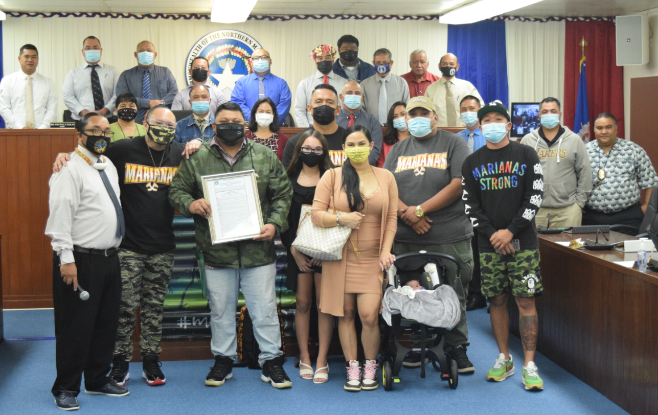 TRIBE Marianas owner Robert Travilla, second left, and associate Thomas Manglona pose with family members and lawmakers during the presentation of House Commemorative Resolution 21-14 on Tuesday.Photo by Emmanuel T. Erediano