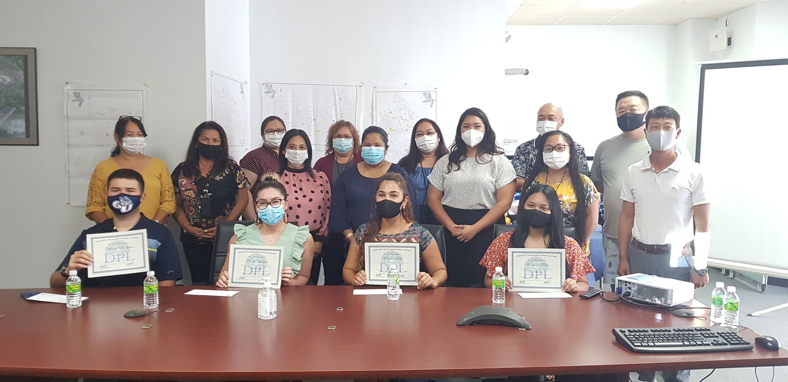 Winners of the first ever DPL indigenous scholarship essay contest pose with the DPL team and lessees on Wednesday in the DPL conference room.