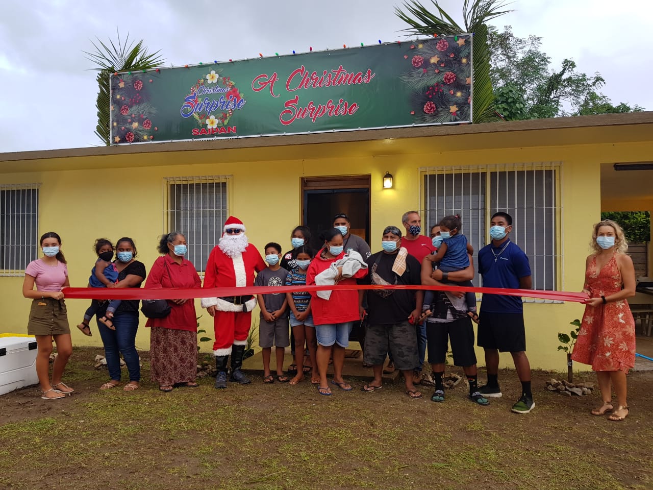 The Omelau family and organizers of  “A Christmas Surprise on Saipan” pose for a photo.Photo by Jaki Fujihara