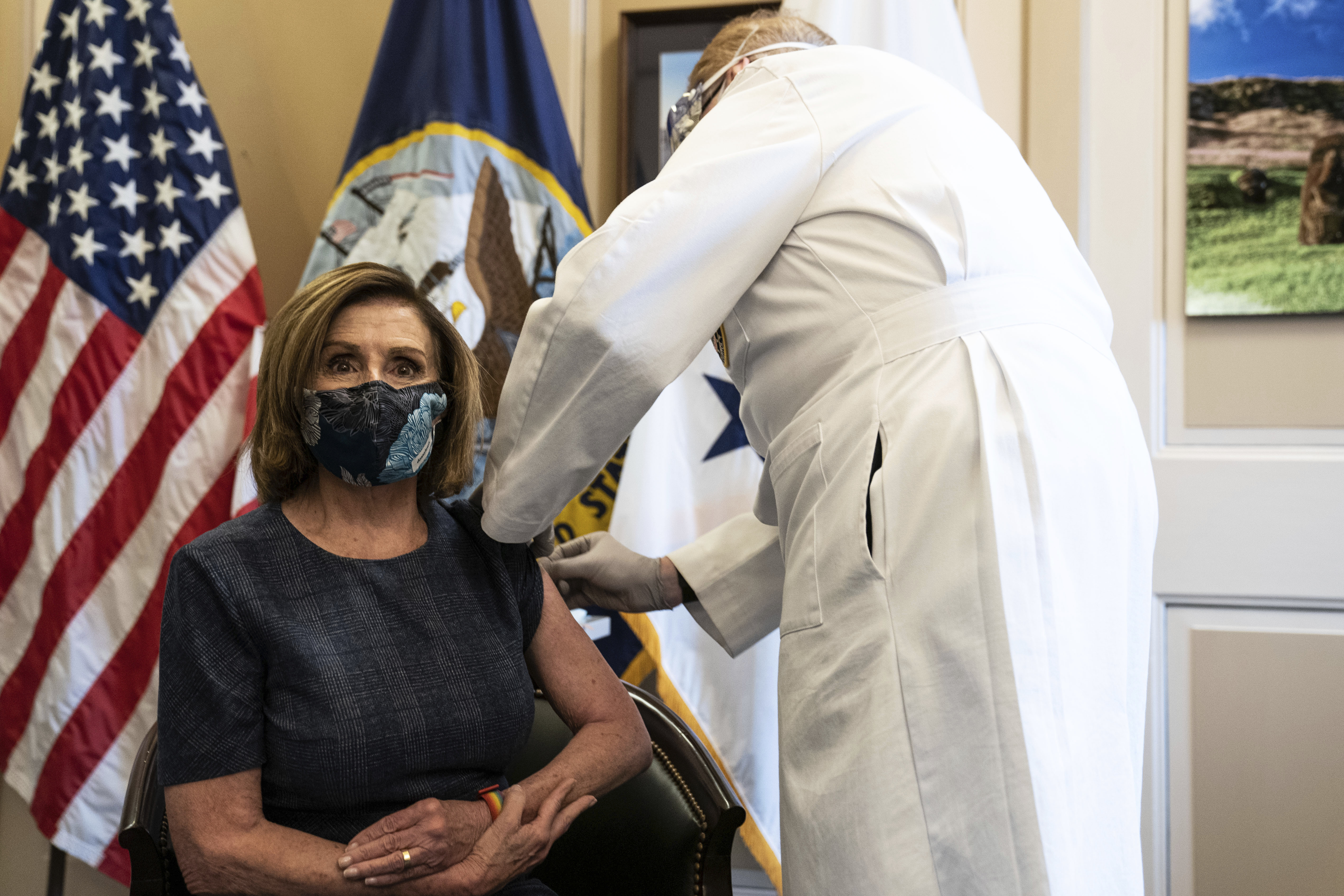 Speaker of the House Nancy Pelosi, D-Calif., receives a Pfizer-BioNTech Covid-19 vaccine shot by Dr. Brian Monahan, attending physician of the U.S. Congress, in Washington, D.C. on Dec. 18, 2020.AP