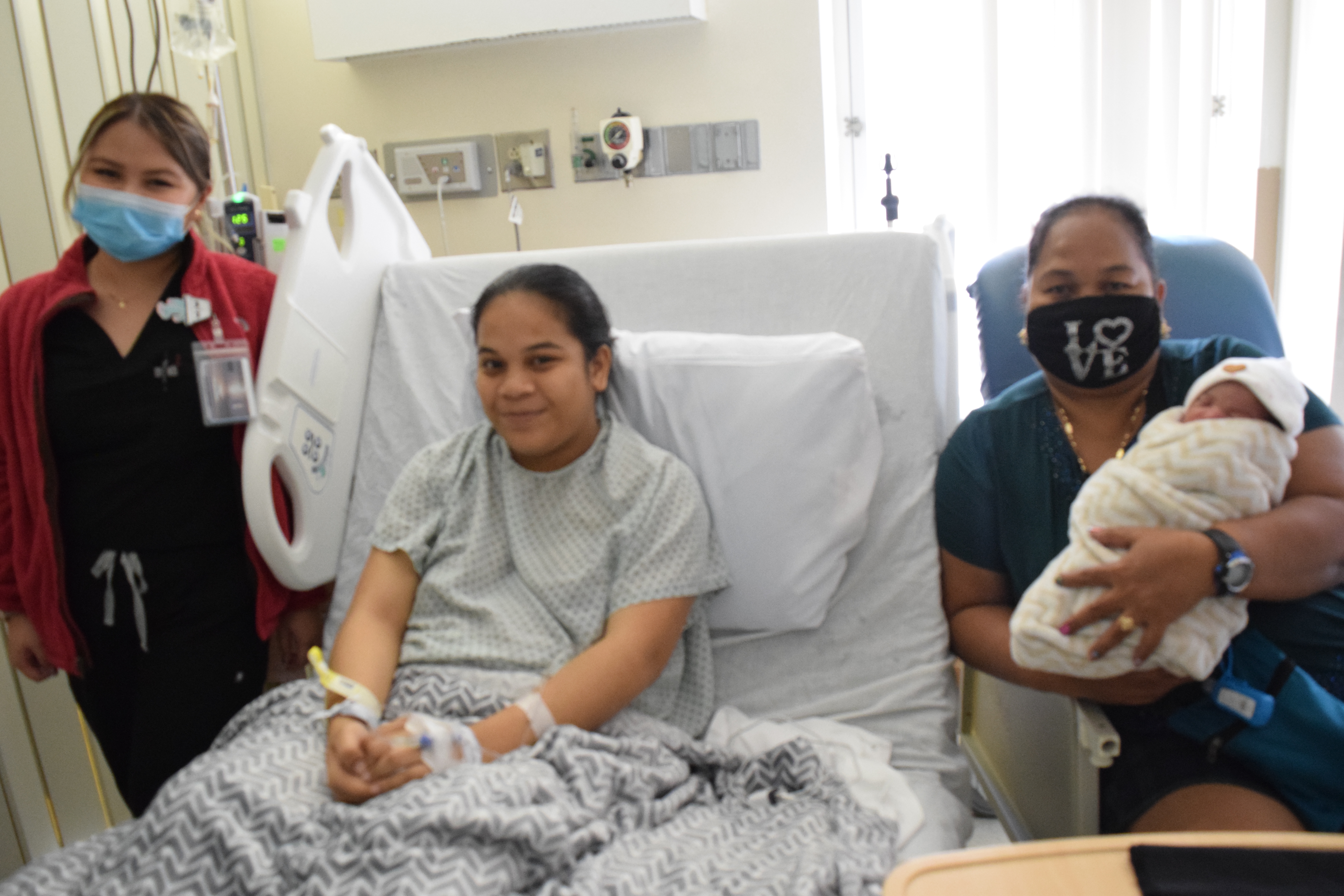 Baby girl Riamaya Nartin is carried by her grandmother, Niuri Marcus, right, in a recovery room of the Commonwealth Health Center. Also in photo is the baby’s mother, Richelle, center, and nurse Joy Waldo, left.Photo by Emmanuel T. Erediano