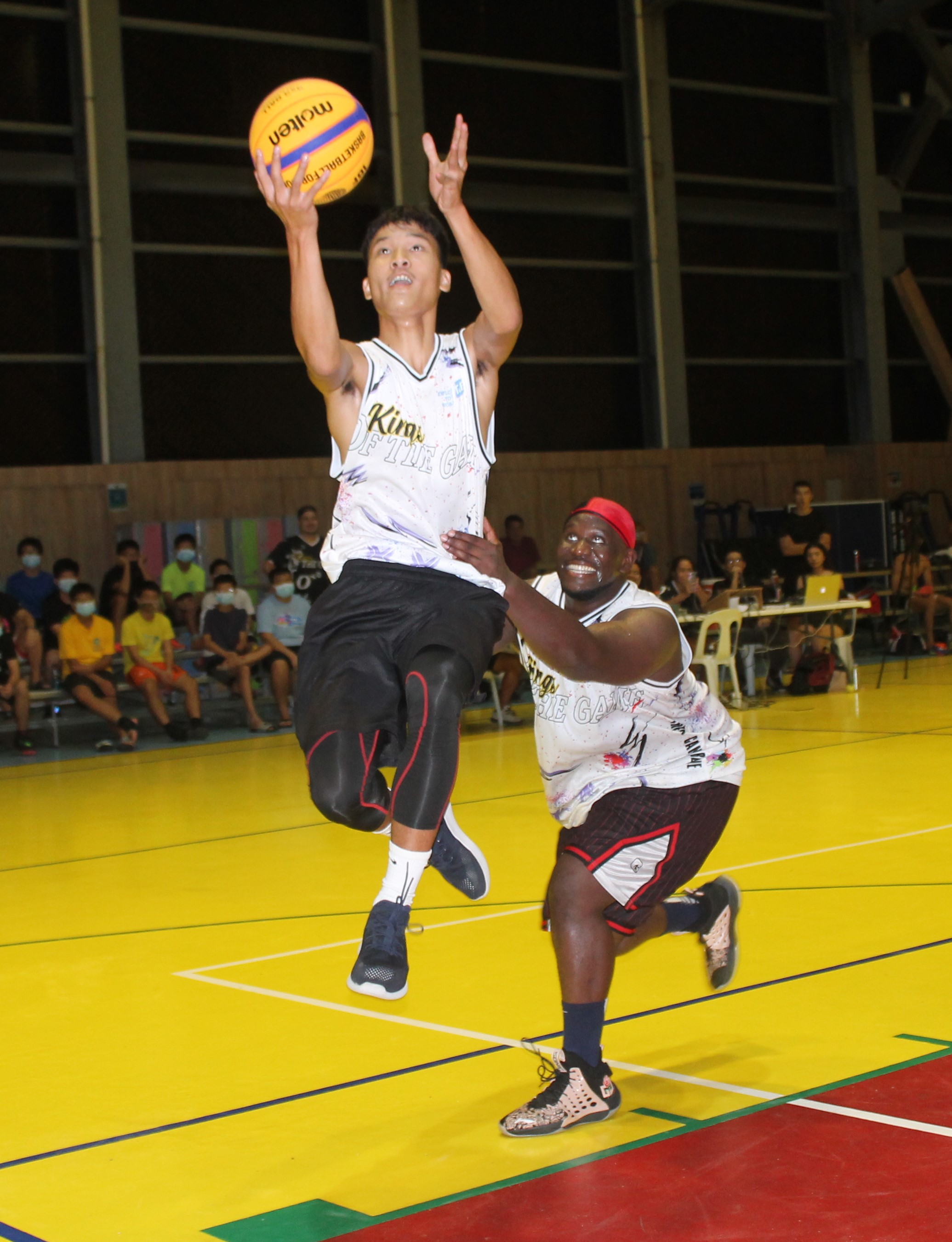 Richard McWilliams fouls Coby Santos in midair during a Kings of the Game match at the ACS gym.Photo by James F. Sablan Jr.